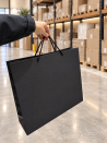 Black paper bag with black cord handles