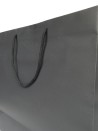 Black paper bag with black cord handles